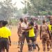 Referee Bremansu being escorted off the field by some Prisons officers after the assault (Image credit: Sika Photos)