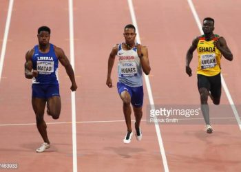DOHA, QATAR - SEPTEMBER 27: (L-R) Emmanuel Matadi of Liberia, Zharnel Hughes of Great Britain, and Joseph Paul Amoah of Ghana compete in the Men's 100 metres heats during day one of 17th IAAF World Athletics Championships Doha 2019 at Khalifa International Stadium on September 27, 2019 in Doha, Qatar. (Photo by Patrick Smith/Getty Images)