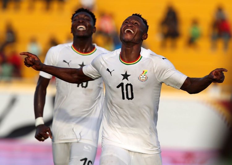Esso (in jersey number 10) celebrating his goal for Ghana against The Gambia