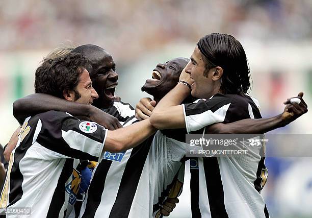TURIN, ITALY:  Juventus Alessandro Del Piero (L), Lilian Thuram and Adrian Mutu celebrate Stephen Appiah (C) after he scored a third goal against Cagliari during the last  Serie A football match of the season in Turin's Delle Alpi Stadium 29 May 2005. AFP PHOTO/ Filippo MONTEFORTE  (Photo credit should read FILIPPO MONTEFORTE/AFP via Getty Images)
