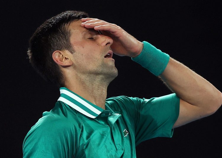 (FILES) This file photo taken on February 16, 2021 shows Serbia's Novak Djokovic reacting after losing a point against Germany's Alexander Zverev during their men's singles quarter-final match on day nine of the Australian Open tennis tournament in Melbourne. - Novak Djokovic lost his bid to avoid deportation from Australia on January 16, 2022, with a Federal Court unanimously rejecting his appeal to stay in the country and defend his Australian Open title. (Photo by Brandon MALONE / AFP) / -- IMAGE RESTRICTED TO EDITORIAL USE - STRICTLY NO COMMERCIAL USE --