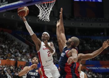 Canada guard Shai Gilgeous-Alexander (2) shoots against France forward Nicolas Batum (5) during the Basketball World Cup group H match between France and Canada at the Indonesia Arena stadium in Jakarta, Indonesia, Friday, Aug. 25, 2023. (AP Photo/Dita Alangkara)