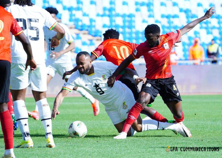 Jordan Ayew gets fouled by Ugandan players