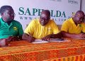 Greater Accra Hockey Association Vice Chairman Derrick Tamakloe (middle right) and Head of Sales and Marketing for Sapholda Ventures Ebo Acquaye (middle left) sign sponsorship documents.
