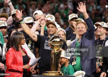 Head coach Joe Mazzulla of the Boston Celtics celebrates in front of the Larry O’Brien Championship Trophy after Boston's 106-88 win against the Dallas Mavericks in Game Five of the 2024 NBA Finalls (Photo by Elsa/Getty Images)