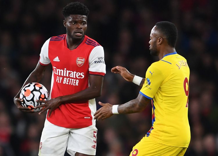 Thomas Partey holds onto the ball as Jordan Ayew (Photo by David Price/Arsenal FC via Getty Images)