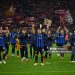 Hakan Çalhanoglu (L), Lautaro Martínez (C), and Francesco Acerbi (R) of FC Internazionale celebrate in front of their teammates after a 1-2 win over Bayern Munich (Photo by Marco Mantovani/Getty Images)