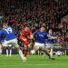 Diogo Jota of Liverpool scores his team's first goal under pressure from James Tarkowski of Everton (Photo by Carl Recine/Getty Images)