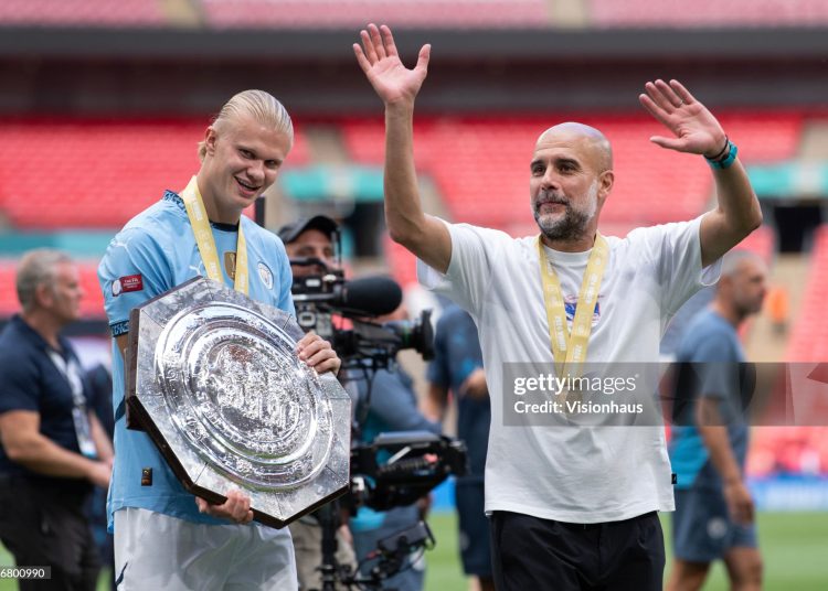 Erling Haaland of Manchester City and manager Pep Guardiola with the trophy (Photo by Visionhaus/Getty Images)