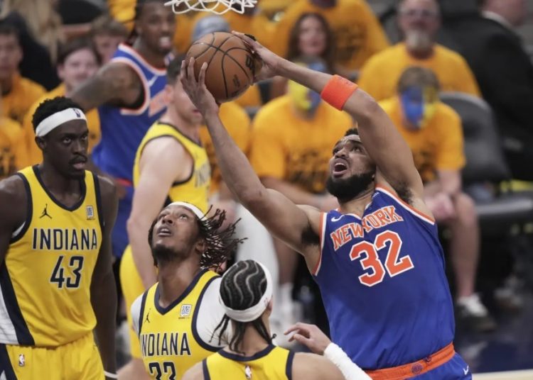 Karl-Anthony Towns grabs rebound against Indiana Pacers Photo Courtesy: AP