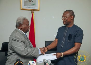 Major Retired Amarkai Amarteifio (left) presents report to Sports Minister Kofi Adams