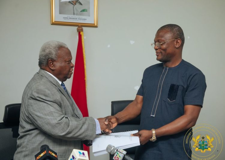 Major Retired Amarkai Amarteifio (left) presents boxing report to Sports Minister Kofi Adams