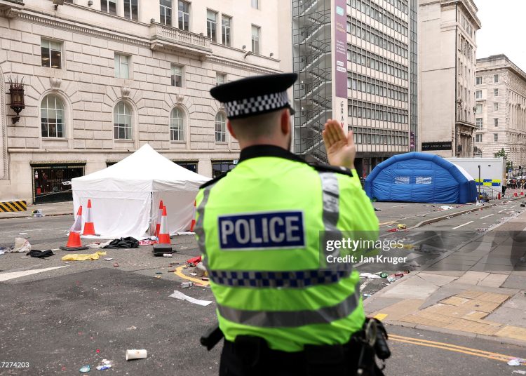 A police officer stands guard at the entrance of Water Street on May 27, 2025 in Liverpool, England. Investigation and cleanup continued this morning after a car ploughed into a crowd gathered yesterday for the Liverpool F.C. victory parade, injuring nearly 50 people, including four children. Authorities said the suspect was arrested and they are not treating it as an act of terrorism. (Photo by Jan Kruger/Getty Images)