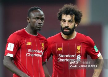 Liverpool's Senegalese striker Sadio Mane (L) speaks with Liverpool's Egyptian midfielder Mohamed Salah (Photo by KARIM JAAFAR / AFP) (Photo by KARIM JAAFAR/AFP via Getty Images)