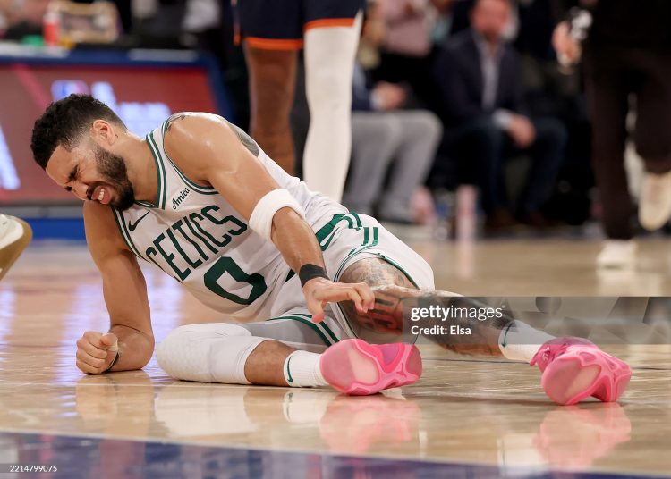 Jayson Tatum #0 of the Boston Celtics lays on the ground after being injured against the New York Knicks (Photo by Elsa/Getty Images)