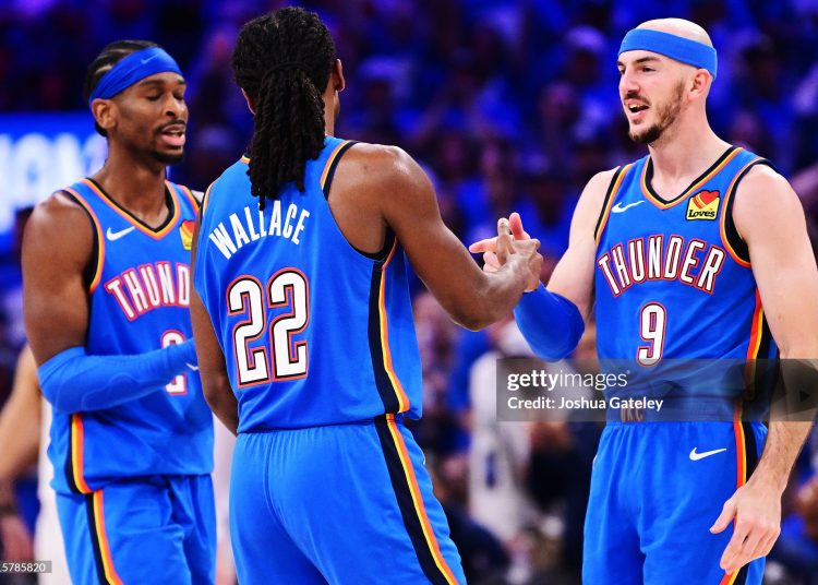 Alex Caruso #9, Cason Wallace #22 and Shai Gilgeous-Alexander #2 of the Oklahoma City Thunder react during the fourth quarter against the Denver Nuggets (Photo by Joshua Gateley/Getty Images)