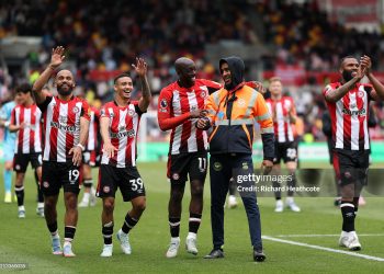 Bryan Mbeumo, Gustavo Nunes, Yoane Wissa and Igor Thiago  celebrate victory with a steward following the Premier League match between Brentford FC and Manchester United FC (Photo by Richard Heathcote/Getty Images)