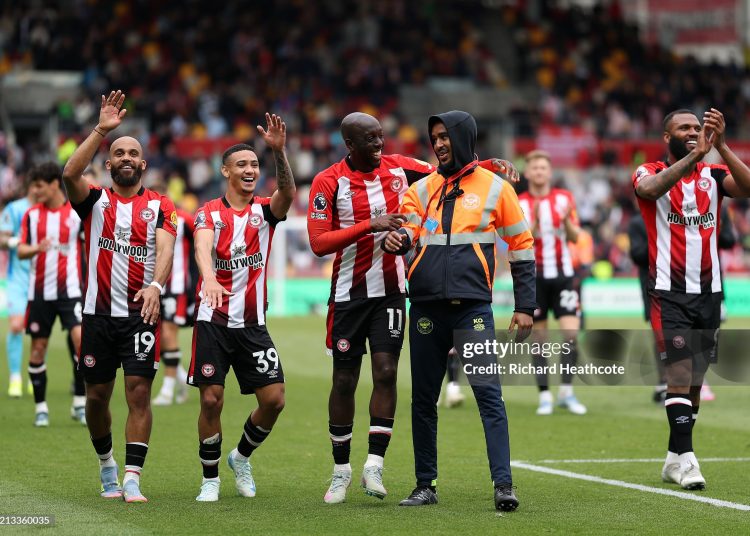 Bryan Mbeumo, Gustavo Nunes, Yoane Wissa and Igor Thiago  celebrate victory with a steward following the Premier League match between Brentford FC and Manchester United FC (Photo by Richard Heathcote/Getty Images)