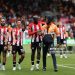 Bryan Mbeumo, Gustavo Nunes, Yoane Wissa and Igor Thiago  celebrate victory with a steward following the Premier League match between Brentford FC and Manchester United FC (Photo by Richard Heathcote/Getty Images)