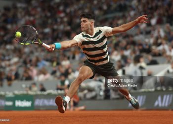 PARIS, FRANCE - MAY 28: Carlos Alcaraz of Spain plays a backhand against Fabian Marozsan of Hungary during the Men's Singles Second Round match on Day Four of the 2025 French Open at Roland Garros on May 28, 2025 in Paris, France. (Photo by Adam Pretty/Getty Images)