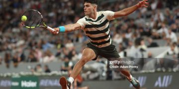 PARIS, FRANCE - MAY 28: Carlos Alcaraz of Spain plays a backhand against Fabian Marozsan of Hungary during the Men's Singles Second Round match on Day Four of the 2025 French Open at Roland Garros on May 28, 2025 in Paris, France. (Photo by Adam Pretty/Getty Images)