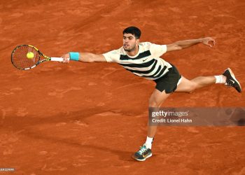 Carlos Alcaraz of Spain plays a forehand against Lorenzo Musetti of Italy (Photo by Lionel Hahn/Getty Images)