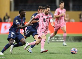 Lionel Messi #10 of Inter Miami CF runs with the ball while under pressure from Nuno Mendes #25 and Joao Neves #87 of Paris Saint-Germain during the FIFA Club World Cup 2025 (Photo by Alex Grimm/Getty Images)