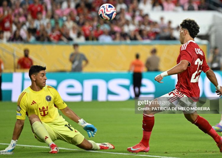 Al Ahly's Egyptian midfielder #22 Emam Ashour attempts a shot on goal in front of Inter Miami's Argentine goalkeeper #19 Oscar Ustari during the Club World Cup 2025 (Photo by PATRICIA DE MELO MOREIRA/AFP via Getty Images)