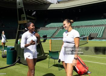 Coco Gauff of the United States and Aryna Sabalenka create content for social media after training together on Centre Court in preparation for the 2025 Wimbledon (Photo by Tim Clayton/Getty Images)