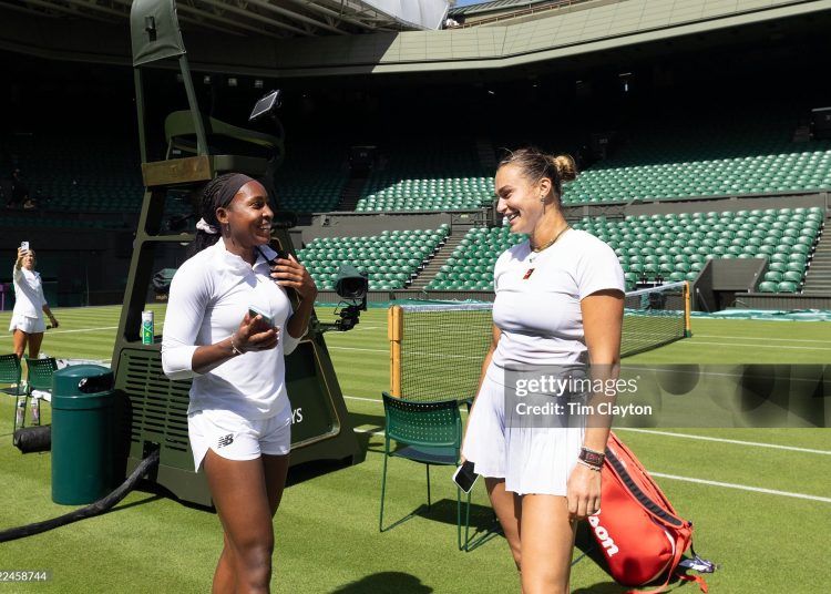 Coco Gauff of the United States and Aryna Sabalenka create content for social media after training together on Centre Court in preparation for the 2025 Wimbledon (Photo by Tim Clayton/Getty Images)