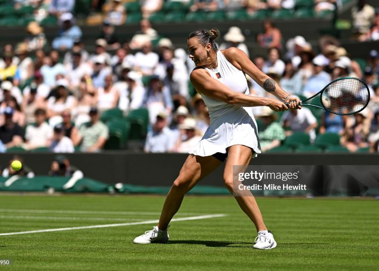 Aryna Sabalenka plays a backhand against Carson Branstine of Canada during the Ladies' Singles first round match on day one of The Championships Wimbledon 2025 (Photo by Mike Hewitt/Getty Images)