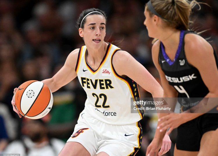 Caitlin Clark #22 of the Indiana Fever drives to the basket against Jacy Sheldon #4 of the Connecticut Sun (Photo by Brian Fluharty/Getty Images)