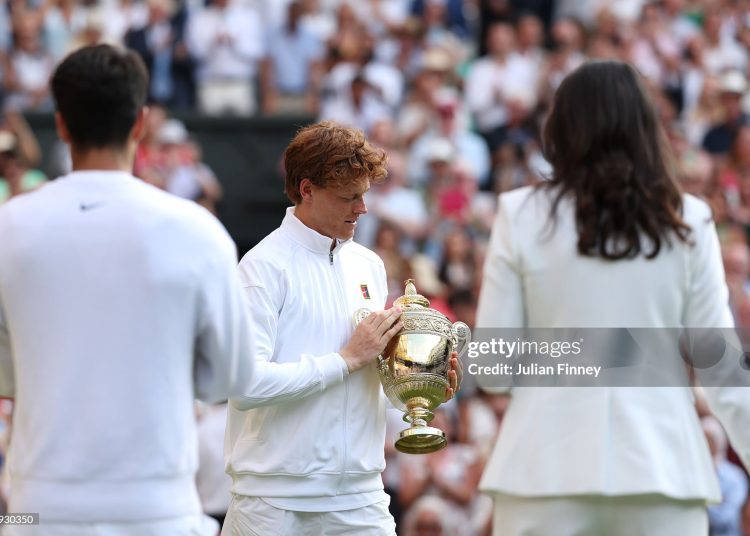 Jannik Sinner admires the Gentlemen’s Singles Trophy following his victory against Carlos Alcaraz. (Photo by Julian Finney/Getty Images)