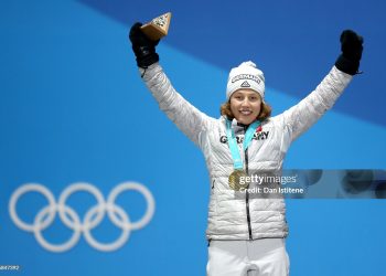 Gold medalist Laura Dahlmeier of Germany celebrates on the podium during the Medal Ceremony for the Women's Biathlon 7.5 km Sprint . (Photo by Dan Istitene/Getty Images)
