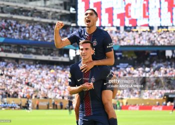 Paris Saint-Germain's Spanish midfielder #08 Fabian Ruiz celebrates scoring his team's third goal with Moroccan defender #02 Achraf Hakimi during the FIFA Club World Cup 2025 semifinal (Photo by ANGELA WEISS/AFP via Getty Images)