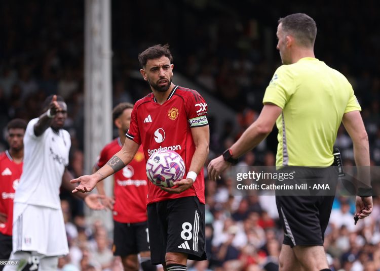 Bruno Fernandes of Manchester United with Referee Chris Kavanagh before taking a penalty (Photo by Catherine Ivill - AMA/Getty Images)