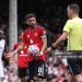 Bruno Fernandes of Manchester United with Referee Chris Kavanagh before taking a penalty (Photo by Catherine Ivill - AMA/Getty Images)