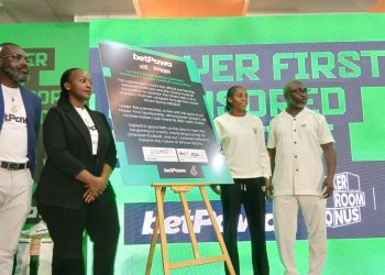 Harrioson Addo with the Captain of Faith Ladies; Beauty Abena  Julius with  Borah Ndanyunga - head of local marketing and CSR -Betpawa