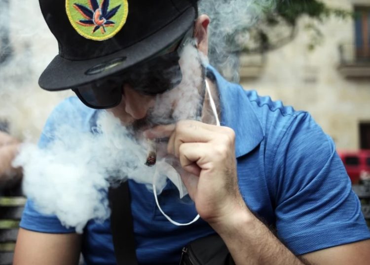 An individual smokes marijuana at a public area Photo Courtesy: Leonardo Alvarez Hernandez / Getty Images file