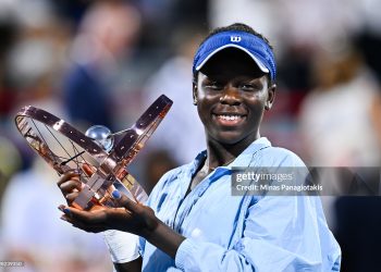 Victoria Mboko of Canada celebrates as she holds up the trophy following her victory against Naomi Osaka of Japan (Photo by Minas Panagiotakis/Getty Images)