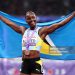 Bronze medalist, Julien Alfred of Team Saint Lucia poses for a photo with the national flag after competing in the Women's 100 Metres Final (Photo by Julian Finney/Getty Images)