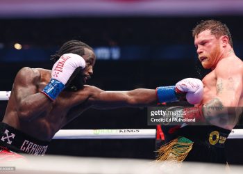 Terence Crawford (blue gloves) punches Canelo Alvarez (red gloves) for the Undisputed & Ring Magazine Super Middleweight Championship (Photo by Ed Mulholland/TKO Worldwide LLC via Getty Images)