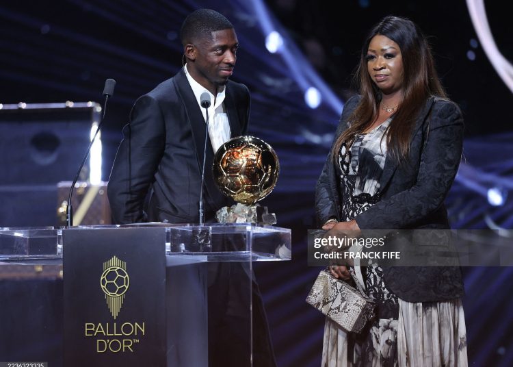 Paris Saint-Germain's French forward Ousmane Dembele stands on stage next to his mother after receiving the Ballon d'Or award during the 2025 Ballon d'Or France Football award ceremony (Photo by FRANCK FIFE/AFP via Getty Images)
