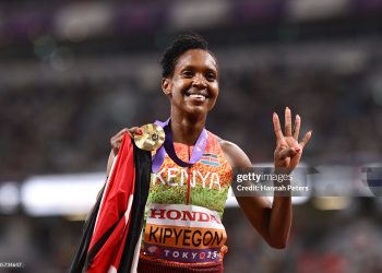 Gold medalist Faith Kipyegon of Team Kenya holds up four fingers as she poses for a photo following the Women's 1500 Metres Final on day four of the 2025 World Athletics Championships (Photo by Hannah Peters/Getty Images)