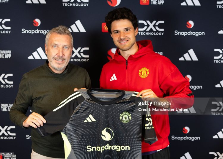 Senne Lammens of Manchester United poses with Director of Football Jason Wilcox  (Photo by Manchester United/Manchester United via Getty Images)