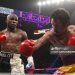 Floyd Mayweather Jr. exchange punches with Manny Pacquiao (Photo credit: JOHN GURZINSKI/AFP via Getty Images)
