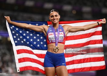 Gold medalist Sydney McLaughlin-Levrone of Team United States poses for a photo with the national flag of United States after winning the Women's 400 Metres Final (Photo by Hannah Peters/Getty Images)