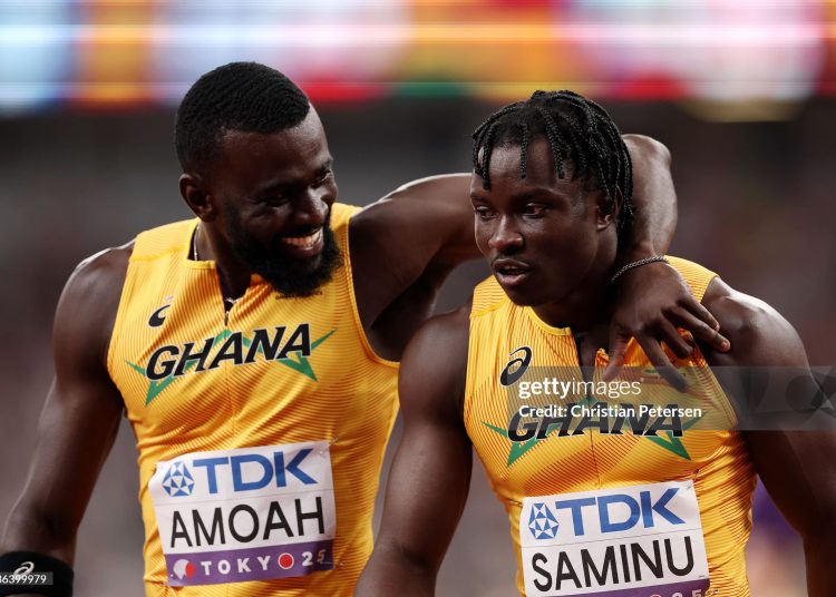 TOKYO, JAPAN - SEPTEMBER 20: Joseph Paul Amoah embraces teammate Abdul-Rasheed Saminu following the Men's 4x100m Relay Heats on day eight of the World Athletics Championships Tokyo 2025 at National Stadium on September 20, 2025 in Tokyo, Japan.  (Photo by Christian Petersen/Getty Images)