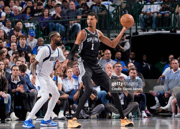 Victor Wembanyama #1 of the San Antonio Spurs handles the ball as Naji Marshall #13 of the Dallas Mavericks plays defense during the game (Photo by Glenn James/NBAE via Getty Images)