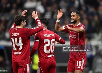 Cody Gakpo of Liverpool celebrates scoring his team's fourth goal with teammates Federico Chiesa and Andrew Robertson during the UEFA Champions League 2025/26 League Phase MD3 match between Eintracht Frankfurt and Liverpool FC (Photo by Christian Kaspar-Bartke/Getty Images)
